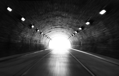 defocused photo on light at the end of tunnel 