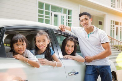 beautiful family portrait smiling outside their new house, just arrive new home by car.