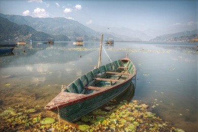 phewa lake - the second largest lake in nepal located in the pokhara valley near the town and the mountain sarangkot.