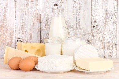 dairy products on wooden background 