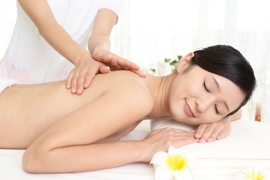 young woman getting a massage in a spa 