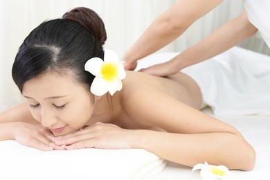 young woman getting a massage in a spa 