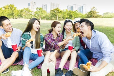 happy young friends enjoying  healthy picnic