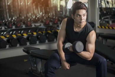 man with weight training equipment on sport gym club