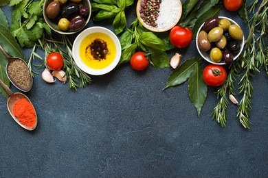 high angle view of italian food ingredientsbbackground with herbs, olives, oil and tomatoes. empty space for your text