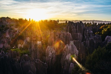 colorful sunset in stone forest in shilin, yunnan province, south china, not far from the  kunming. it is the world-famous natural area of limestone formations and unesco world heritage site.