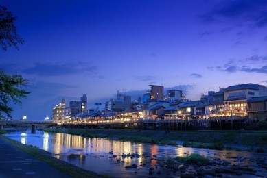 old houses and restaurants along the kamogawa (kamo river) in kyoto, japan,at dusk.
