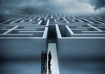 business people looking at maze against digitally generated background