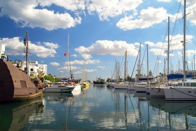 sea port in el-kantaoui, tunisia with white yachts and blue sky reflected on a water