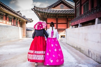 korean girls dressed hanbok in traditional dress walking in gyeongbokgung palace, seoul, south korea