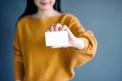 woman holding blank business card for mock up