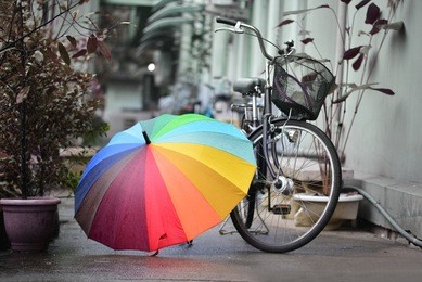 colorful umbrella and bicycle in rainy day
