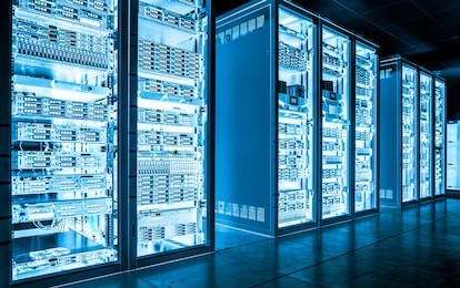 big data dark server room with bright blue equipment