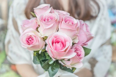 hands holding bouquet of flower - vintage lighting style