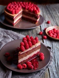 homemade chocolate cake no bake cheesecake with biscuit and fresh raspberries on the rustic wooden table. mousse chocolate. concept of a romantic breakfast. souffle dessert.