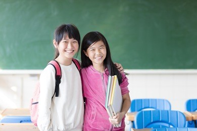 two teenage girls student in the classroom