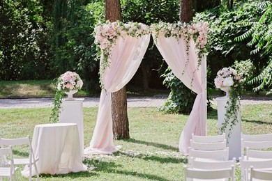 arch for the wedding ceremony, decorated with cloth and flowers