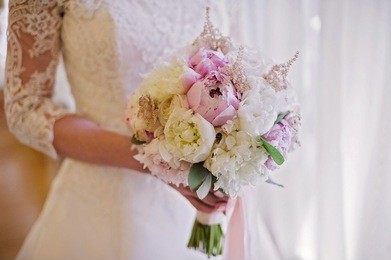 bride holding delicate marriage bouquet