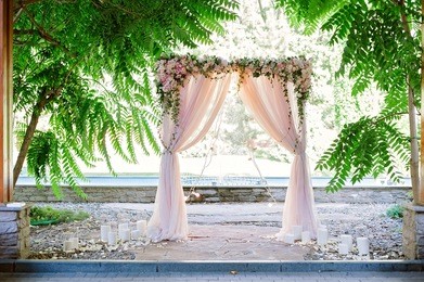 arch for the wedding ceremony, decorated with cloth and flowers