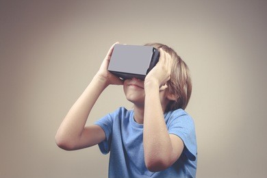 child using new virtual reality, vr cardboard glasses