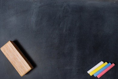 blackboard with colored chalks and eraser. horizontal composition.