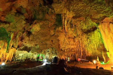 stalagmite and stalactite with color light in the cave
