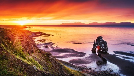 hvitserkur 15 m height. is a spectacular rock in the sea on the northern coast of iceland. on this photo hvitserkur reflects in the sea water after the midnight sunset