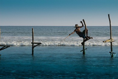 traditional fisherman is fishing near galle in sri lanka. 