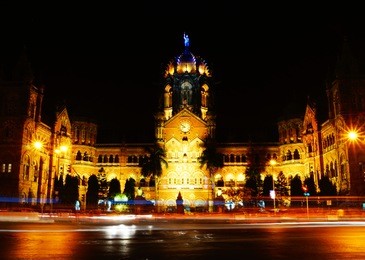 chhatrapati shivaji maharaj terminus (csmt), formerly victoria terminus, is a historic railway station and a unesco world heritage site in mumbai, maharashtra, india. night time. light trail photo.