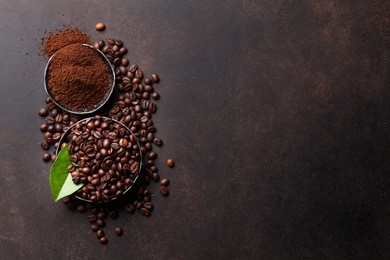 coffee beans and ground powder on stone background. top view with copy space for your text 