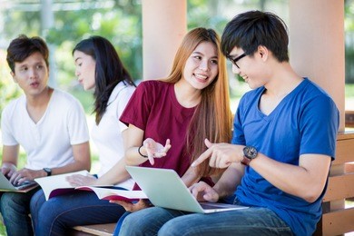 group of students sharing with the ideas on the campus lawn