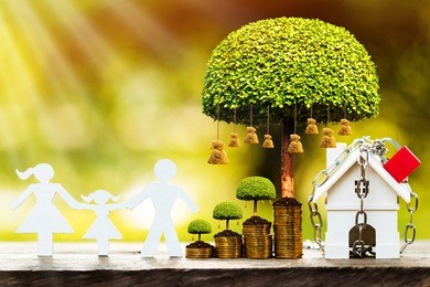 a house model with security and lock and family model and money bag tree with growing in public park, saving money for real estate  and property protection concept.