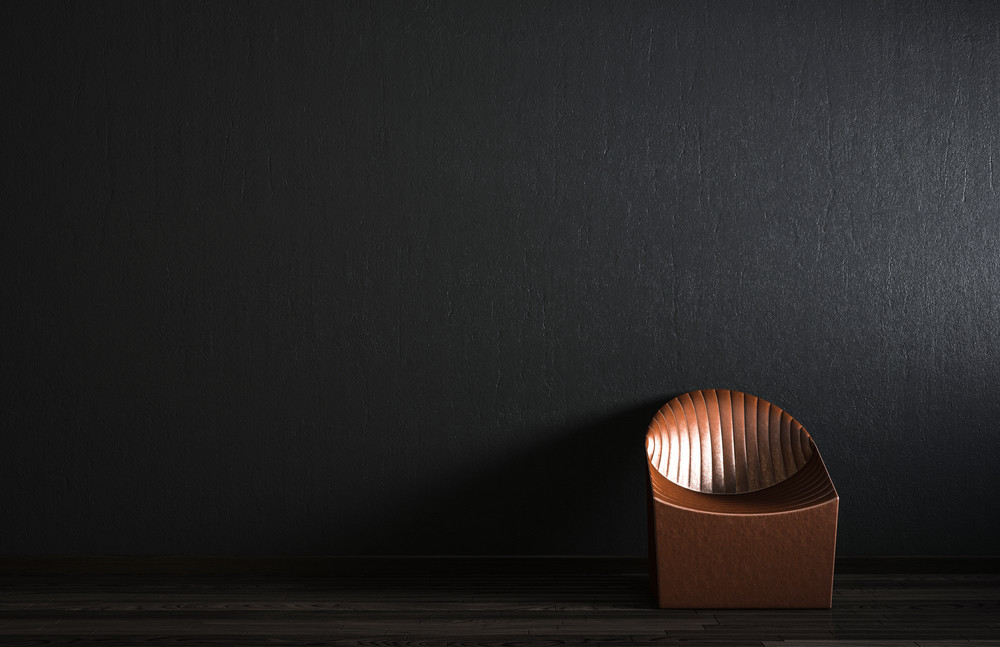 the lather chair in front of the black wall.