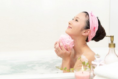 young beautiful woman taking relaxing bath