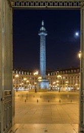 vendome column with statue of napoleon bonaparte, on the place vendome at night, in france. vendome column has 425 spiraling bas-relief bronze plates were made out of cannon.