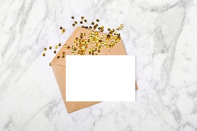 empty card with envelope and gold confetti. mockup template. view from above
