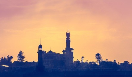 skyline of alexandria town - silhouettes of royal palace and montazah park. montazah national park at sunset - landscape from the travel on mediterranean sea to egypt.