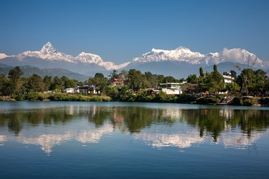 view at annapurna mountain range and its reflection in phewa lake in pokhara, nepal