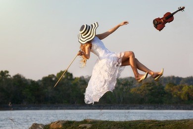 levitation, feeling freedom of every move. studio shot of attractive young woman hovering in air