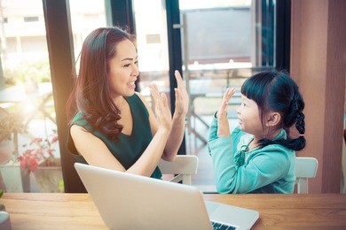 little girl looking at laptop computer with her mom.concept family happy.