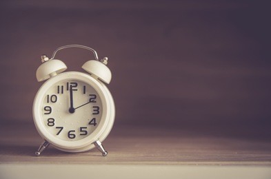 retro alarm clock on a table. photo in retro color image style