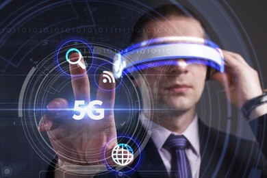 business, technology, internet and network concept. young businessman working in virtual reality glasses sees the inscription: 5g