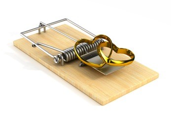 mousetrap with wedding ring on white background. isolated 3d image.