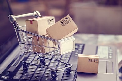 boxes in a trolley on a laptop keyboard. ideas about online shopping, online shopping is a form of electronic commerce that allows consumers to directly buy goods from a seller over the internet.