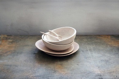 handmade clay dishes on wooden table. pottery making process.