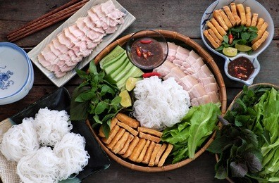 delicious vietnamese food, bun dau mam tom, is popular street food make from vermicelli with boiled meat, fried tofu, shrimp paste and green vegetables, cucumer and spice as chilli, lemon 