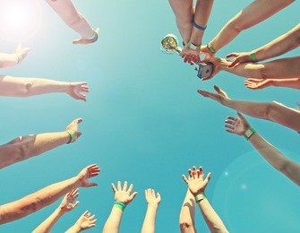 winner team  with a cup, bottom view, background of the bright sky