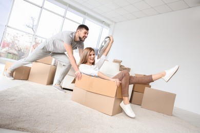 young happy couple packing and having fun. moving concept