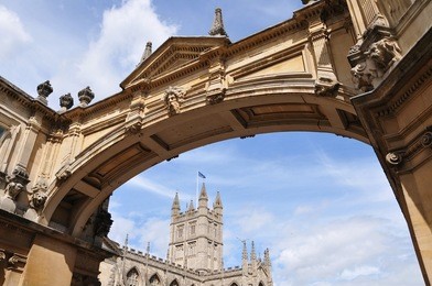 beautiful palladian archway with a view of bath abbey in the background