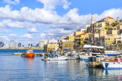 old city jaffa harbor. view to tel aviv. boats docking at the seashore.